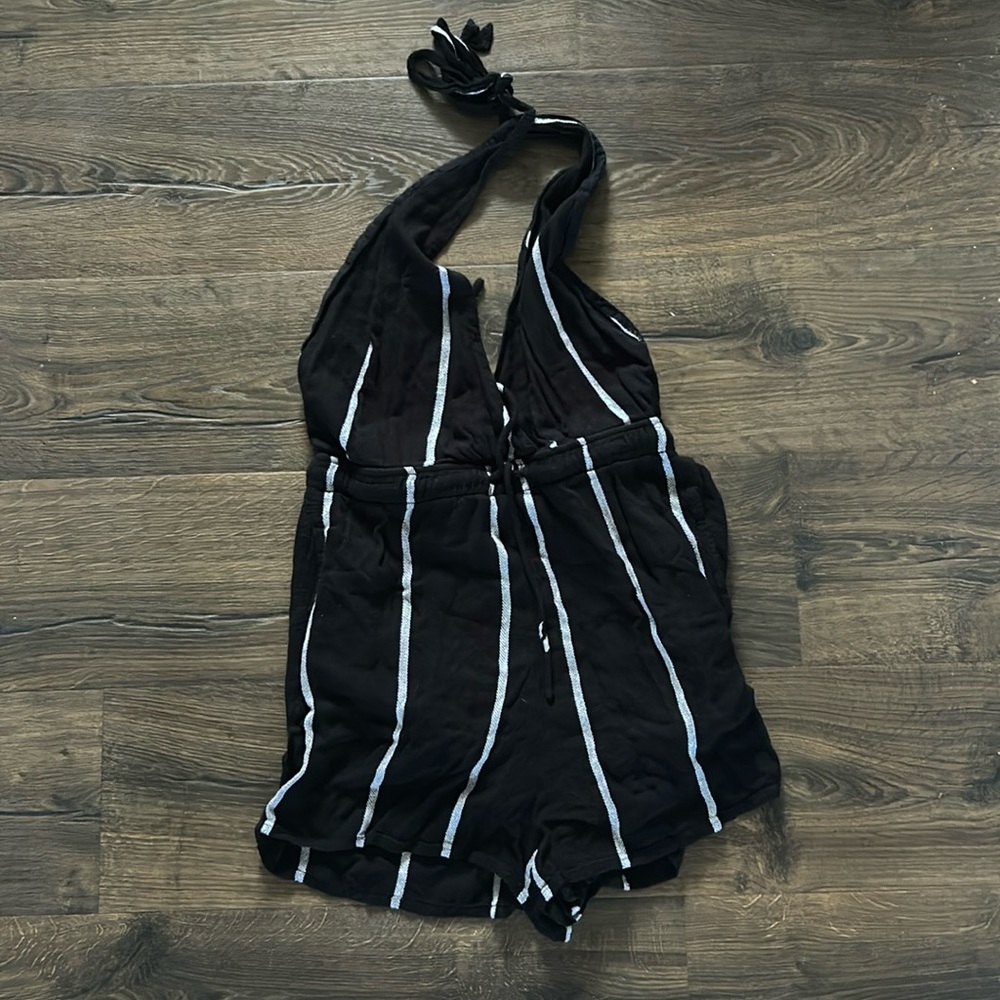 Open back, white striped Volcolm romper with a halter neck